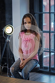 Cute girl in the Studio, the light from the lamp in the background