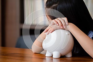 Cute girl tired sleep on piggy bank,saving money concept