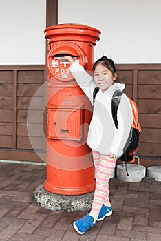 Cute girl tourist sent letter to postbox