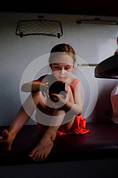 Cute girl in the train. Summer Vacation and Travel Concept. A girl of 5 or 6 years old rides on a train. Teen travels