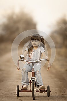 Cute Girl on Tricycle All About the Accessories photo