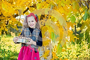 Cute girl with walnuts from the walnut harvest in the garden.