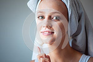 Woman washing cleaning face and skin with brush soap and wather