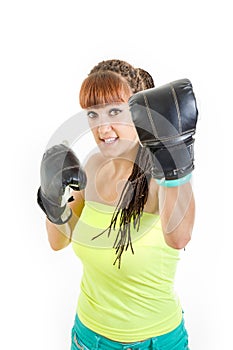 Cute girl wearing boxing gloves ready to fight and standing in c
