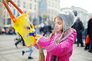 Cute girl wearing frightening masks during the celebration of Uzgavenes, a Lithuanian annual folk festival taking place seven week