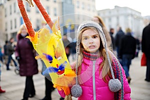 Cute girl wearing frightening masks during the celebration of Uzgavenes, a Lithuanian annual folk festival taking place seven week