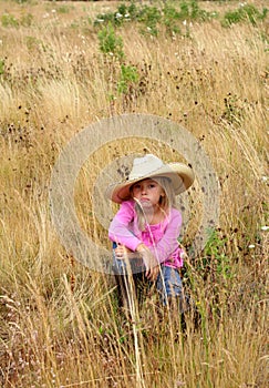 Cute girl wearing a large hat.