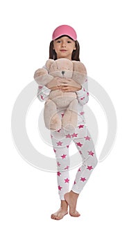 Cute girl wearing pajamas and sleeping mask with teddy on white background