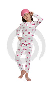 Cute girl wearing pajamas and sleeping mask on white