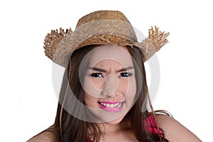 Cute girl wearing a straw hat look unhappy.