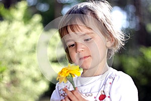 Cute girl with yellow flower photo