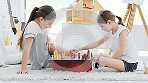 Cute girls kids playing chess game