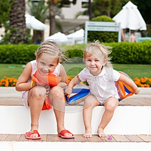 Cute girls preparing to go to swim in armbands