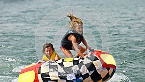 Cute Girls on Tube Behind Boat