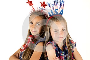 Cute girls wearing American patriotic headbands back to back