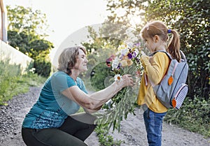 Cute granddaughter hugging her happy grandmother