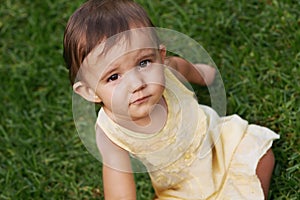 Cute, grass and portrait of girl baby having fun and playing in backyard, park or garden. Nature, sweet and kid, infant