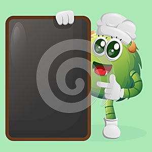 Cute green monster holding menu black Board, menu board, sign board