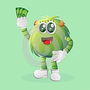 Cute green monster holding money