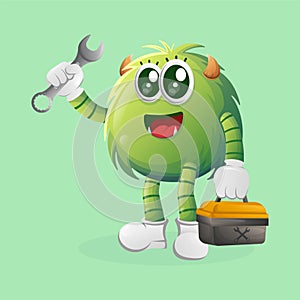 Cute green monster holding spanner and tolls box