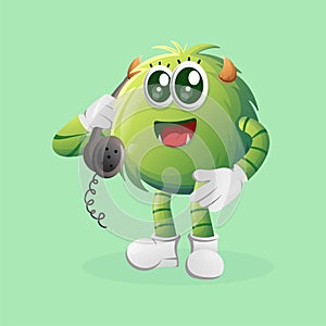 Cute green monster pick up the phone, answering phone calls