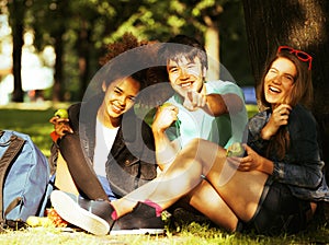 Cute group of teenages at the building of university with books