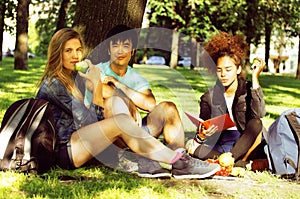 Cute group of teenages at the building of university with books