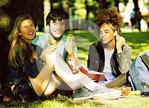 Cute group of teenages at the building of university with books