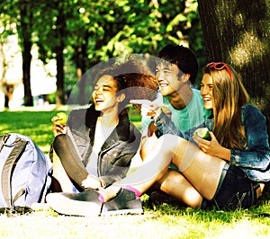 Cute group of teenages at the building of university with books