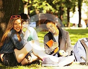 Cute group of teenages at the building of university with books