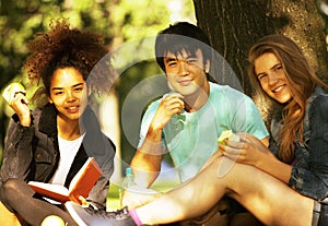 Cute group of teenages at the building of university with books huggings