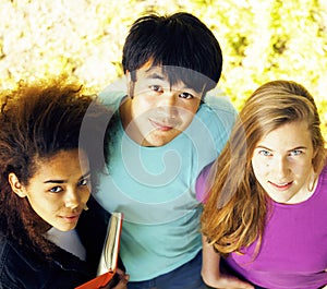 Cute group of teenages at the building of university with books huggings, diversity nations