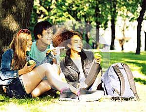 Cute group of teenages at the building of university with books huggings, diversity nations