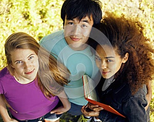 Cute group of teenages at the building of university with books huggings, diversity nations