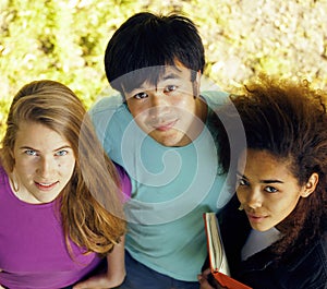 Cute group of teenages at the building of university with books huggings, diversity nations
