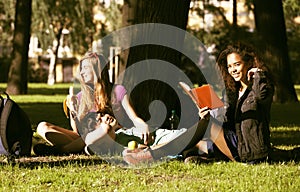 Cute group of teenages at the building of university with books huggings, diversity nations