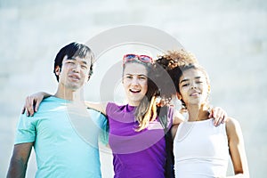 Cute group of teenages at the building of university with books huggings, diversity nations real students lifestyle