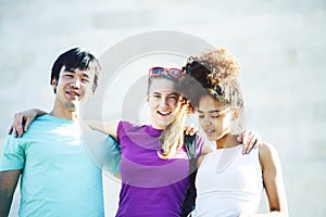 Cute group of teenages at the building of university with books huggings, diversity nations real students lifestyle