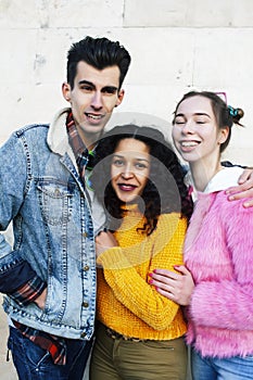 Cute group of teenages at the building of university with books huggings, diversity nations real students lifestyle