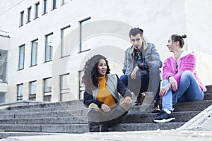 Cute group of teenages at the building of university with books huggings, diversity nations real students lifestyle