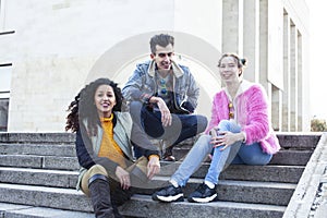 cute group of teenages at the building of university with books huggings, diversity nations real students lifestyle