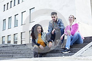 cute group of teenages at the building of university with books huggings, diversity nations real students lifestyle