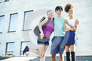 Cute group of teenages at the building of university with books huggings, diversity nations students lifestyle