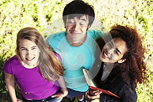 Cute group of teenages in green park at summer with books huggings, diversity nations real students lifestyle