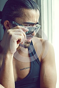 Cute guy looking over sunglasses