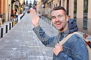 Cute guy saying hi outdoors