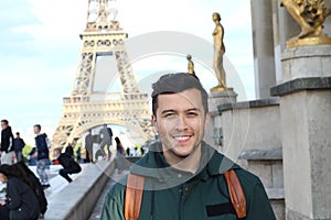 Cute guy taking a touristic picture in France