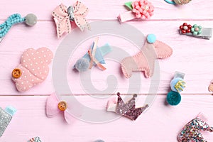 Cute hair clips on pink wooden table