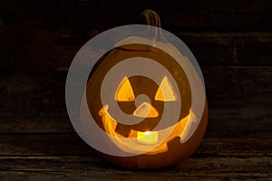 Cute Halloween pumpkin with burning candle.