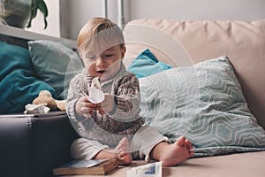 Cute happy 11 month baby boy playing at home, lifestyle capture in cozy interior